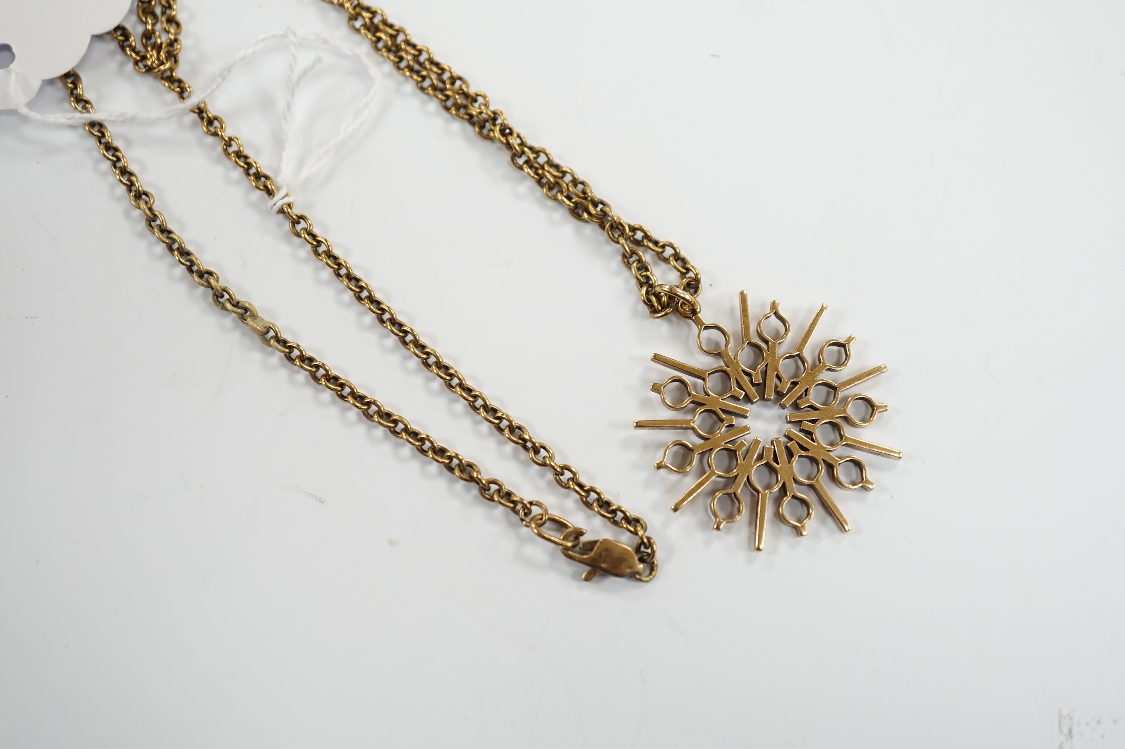 A yellow metal pendant, 37mm, on a 375 chain, 52cm, gross weight 17.8 grams.